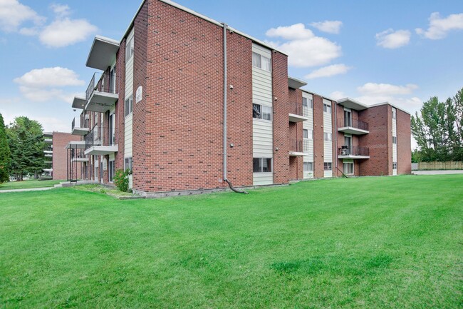 The exterior of the building surrounded by grass - Alderview