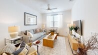 Located at 7733 Burleson Road in Austin, TX, this thoughtfully designed 2-bedroom, 3-bathroom home delivers a clean, contemporary aesthetic throughout its single-floor layout. The living room greets you with warm natural light streaming through large windows dressed in sheer white curtains, complemented by light wood flooring, a ceiling fan, and an inviting, open atmosphere. The kitchen is a standout feature, boasting white shaker cabinetry, a central island with a light countertop, stainless steel appliances, and eye-catching gold pendant lights that add a modern touch. In-unit laundry is conveniently tucked nearby. The primary bedroom is a comfortable retreat with plush carpeting, natural light, a ceiling fan, and direct access to a dedicated walk-in closet equipped with built-in shelving and hanging rods. The second bedroom mirrors the same warm, airy feel. Both closets offer practical storage solutions. The bathrooms are finished in crisp white, featuring subway-tiled tub-shower combinations, wood-look flooring, white vanities with clean countertops, and recessed lighting, creating a spa-like sense of calm. The overall ambiance is bright, neutral, and welcoming — ideal for modern living in the heart of Austin.