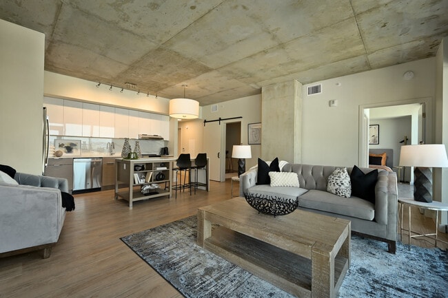 The kitchen and living room of The Piccadilly at Three Light Luxury Apartments - Three Light Luxury Apartments