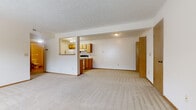 Located at 4600 Emerald Lakes Blvd in Powell, Ohio, this one-bedroom, one-bathroom unit offers a practical and comfortable single-floor layout. The expansive living room is finished with neutral wall-to-wall carpeting and a textured ceiling, and is bathed in natural light from a large window overlooking the surroundings. A tiled entryway provides a clean transition into the carpeted living space. The kitchen is thoughtfully designed with warm oak cabinetry, white appliances including a range and refrigerator, a dishwasher, and light tile flooring. A pass-through opening connects the kitchen to the living area, enhancing the open feel of the space. The bedroom offers a comfortable footprint with soft carpeting, a window with blinds, and easy closet access. The full bathroom includes a single-sink vanity with oak cabinetry, a tub-shower combination, and tile flooring. A dedicated laundry area is equipped with washer and dryer hookups, adding everyday convenience. Throughout the unit, warm wood-toned doors and trim provide a consistent, cohesive aesthetic. A closet and hallway complete the efficient floor plan, making this a well-rounded space suited for comfortable single-occupant living.