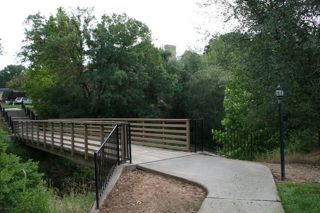 Grounds with bridge over brook - 9200 Madison Ave