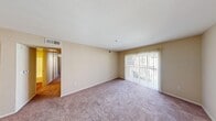 Located at 31990 Castaic Rd in Castaic, CA, this single-story 2-bedroom, 1-bathroom unit offers a practical and efficient layout. The living area is carpeted and filled with natural light, featuring a sliding glass door that opens to the outdoors, complemented by vertical blinds for privacy. Warm beige walls and a textured ceiling create a neutral, move-in-ready atmosphere throughout.

The kitchen is equipped with hardwood-style flooring, wood-toned cabinetry, a white refrigerator, a range, and a built-in sink with ample counter space — a functional setup well-suited for everyday cooking.

Both bedrooms are carpeted and finished with the same warm beige palette. Each room features windows that bring in natural light, and the bedrooms are served by a total of three closets, providing generous storage. The primary bedroom includes a bifold closet door, adding convenience and organization.

The full bathroom includes a combined tub and shower, a single-sink vanity with wood-toned cabinetry, a large mirror, and hardwood-style flooring, offering a clean and straightforward design. A hallway connects the bedrooms and bathroom, contributing to the unit's efficient flow. The overall layout is compact yet well-organized, making thoughtful use of every square foot.