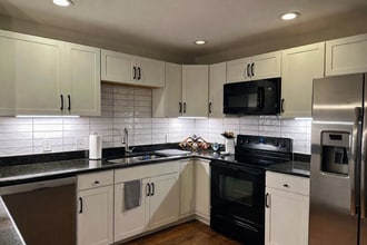 Exceptionally large kitchen for a two-bedroom townhome with eat-at counter and abundant cabinetry. - 524 Superior St