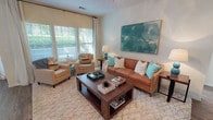 This thoughtfully designed 2-bedroom, 2-bathroom single-floor residence offers a comfortable and stylish layout ideal for modern living. The living room serves as the heart of the home, featuring a ceiling fan, large windows that invite abundant natural light, and views of lush greenery outdoors. The kitchen is outfitted with dark espresso cabinetry, granite-style countertops, black appliances, and wood-look flooring, providing both functionality and a classic aesthetic. Adjacent to the kitchen, the dining area accommodates an intimate dining setup and benefits from large windows framing outdoor greenery. Each bedroom is carpeted and generously sized, with ceiling fans and ample natural light. The primary bedroom includes direct access to its own bathroom. Both bathrooms feature wood-look flooring, dark vanity cabinetry with light countertops, and tasteful finishes throughout. A dedicated laundry room with wood-look flooring adds everyday convenience. Neutral tones and warm accents unify the space, creating a cohesive and inviting ambiance throughout the residence.