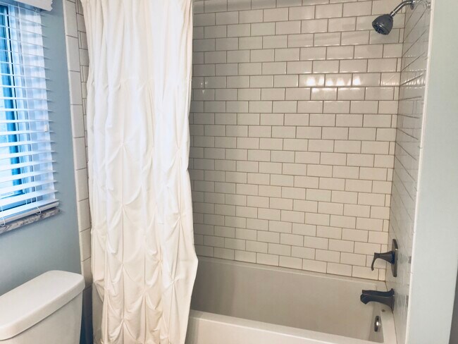 new deep soaking tub, with new subway tile - 8827 CORINNE ST