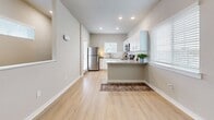 Located at 37136 Eiland Blvd in Zephyrhills, FL, this well-designed 2-bedroom, 2-bathroom residence offers a comfortable and modern living experience. The open-concept kitchen is outfitted with white cabinetry, granite countertops, a peninsula breakfast bar, and stainless steel appliances, all complemented by light wood-look flooring and recessed lighting. Natural light flows throughout via multiple windows dressed with clean white blinds. The primary bedroom features light wood-look flooring, a ceiling fan, a wall-mounted mini-split unit, and a window with outdoor views. The second bedroom is carpeted and includes a sliding double-door closet, a wall-mounted mini-split, and windows that invite natural light. Both bathrooms are finished with granite vanity countertops, light wood cabinetry with modern hardware, and tub-shower combinations. A hallway connects the living spaces, while a staircase with light wood treads and white risers provides access to the unit. The private balcony offers pleasant outdoor views of the surrounding landscaping and community grounds, completing this functional and attractively finished Florida residence.