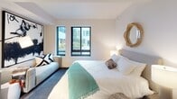 Located in Washington, DC's vibrant Capitol Riverfront neighborhood, this single-floor residence at 1250 Half St SE offers a thoughtfully designed layout with a clean, modern aesthetic throughout. The bedroom is a serene retreat, featuring plush carpeting, warm neutral tones, and large black-framed windows that usher in generous natural light and views of the surrounding greenery. A cozy seating area adds flexibility to the space. The open living and dining area transitions seamlessly from the bedroom, showcasing rich hardwood-style flooring, recessed lighting, and a compact dining nook with a round table — ideal for everyday meals or intimate gatherings. Louvered closet doors provide practical storage while maintaining the space's clean lines. The kitchen is a standout, equipped with stainless steel appliances — including a range, microwave, refrigerator, and dishwasher — complemented by light wood cabinetry that reaches the ceiling, white quartz countertops, and a neutral tile backsplash. The full bathroom features a tub-shower combination, large-format tile flooring, a wall-mounted vanity with an undermount sink, and crisp white walls that lend a contemporary, spa-like feel. Together, these spaces create a cohesive and functional home.
