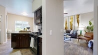 This single-story residence offers a thoughtfully designed layout that balances comfort and functionality throughout its interconnected spaces. The living room serves as the heart of the home, featuring wood-style flooring, vaulted ceilings, and a ceiling fan. A sliding glass door leads to a private outdoor patio, filling the space with natural light. The open layout flows naturally into the dining area, which benefits from a large window overlooking the exterior.

The kitchen is equipped with dark espresso cabinetry, granite countertops, black appliances including a gas range with microwave overhead, a refrigerator, and a double-basin sink. A dedicated laundry area with a full-size washer and dryer is conveniently accessible from the kitchen.

The bedrooms feature plush carpeting, ceiling fans, and generous closet space, including walk-in configurations in select rooms. Sliding glass doors in the primary bedroom provide direct outdoor access and abundant natural light. The bathroom continues the granite countertop theme with dark cabinetry, a wide vanity mirror, and a tub-shower combination, maintaining a consistent, cohesive aesthetic throughout the residence.
