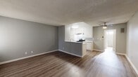 Located at 19950 Roscoe Blvd in the Winnetka neighborhood of Los Angeles, CA, this single-floor unit offers a clean, modern aesthetic throughout. The open-concept living and dining area is finished with durable wood-look vinyl plank flooring and neutral gray walls, creating a bright and cohesive atmosphere. A ceiling fan provides additional comfort, while large windows fitted with vertical blinds invite natural light into the living space.

The kitchen is defined by a peninsula counter that separates it from the living area, offering a practical breakfast bar setup. White cabinetry with stone-look countertops pairs with stainless steel appliances, including a gas range and a full-size refrigerator. A ventilation hood and sink complete the functional layout.

The bedroom is a well-proportioned retreat, featuring the same wood-look flooring, generous natural light from a side window, and a mirrored sliding-door closet that adds depth to the room.

The bathroom is thoughtfully appointed with a shower-tub combination, a window for natural ventilation, white cabinetry with a stone-look vanity top, and matching wood-look flooring. Textured ceilings are present throughout, adding a classic touch to the overall design of this well-maintained Los Angeles unit.