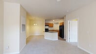 Located at 140 N Davis Rd in LaGrange, Georgia, this well-appointed one-bedroom, one-bathroom unit offers a thoughtfully designed single-level layout. The entry foyer opens into a combined living, dining, and kitchen area that makes efficient use of the space. The kitchen is equipped with warm wood cabinetry, dark granite countertops, black appliances including a range and refrigerator, and a peninsula that doubles as a breakfast bar. Track lighting illuminates the kitchen, while a pendant chandelier adds a decorative touch to the dining area. The living room features plush carpeting, a ceiling fan, and multiple windows alongside a glass door that floods the space with natural light and provides access to an outdoor area. The generously sized bedroom also features carpet flooring, a ceiling fan, and two windows that invite natural light and outdoor views. Two closets serve the unit, including a walk-in closet with wire shelving for ample storage. The bathroom is finished with a wood vanity topped with dark granite, a tub-shower combination, and hardwood-style flooring. A dedicated laundry room with washer/dryer hookups and a water heater completes this functional and comfortable home.
