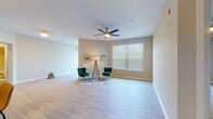 Situated in the desirable Westchase community of Tampa, FL, this single-floor residence at 12065 Tuscany Bay Dr offers a well-designed, open layout with a clean, contemporary aesthetic throughout. The expansive living area is finished with light wood-tone flooring and neutral warm-beige walls, creating a bright and welcoming atmosphere. Large windows with blinds invite abundant natural light, while ceiling fans contribute to comfort year-round. The kitchen is efficiently designed with white cabinetry, light quartz-style countertops, a soft blue tile backsplash, and a full suite of stainless steel appliances including a refrigerator, electric range, and over-the-range microwave. The bedrooms are well-proportioned and bright, each featuring ceiling fans, wood-look flooring, and generous closet storage with louvered bi-fold doors. Both full bathrooms are outfitted with white vanities, quartz countertops, tub-shower combinations, and wood-look tile flooring. A dedicated in-unit laundry area adds everyday convenience. The space is unified by consistent flooring, neutral tones, and clean finishes throughout, offering a comfortable and functional living environment in one of Tampa's sought-after suburban neighborhoods.