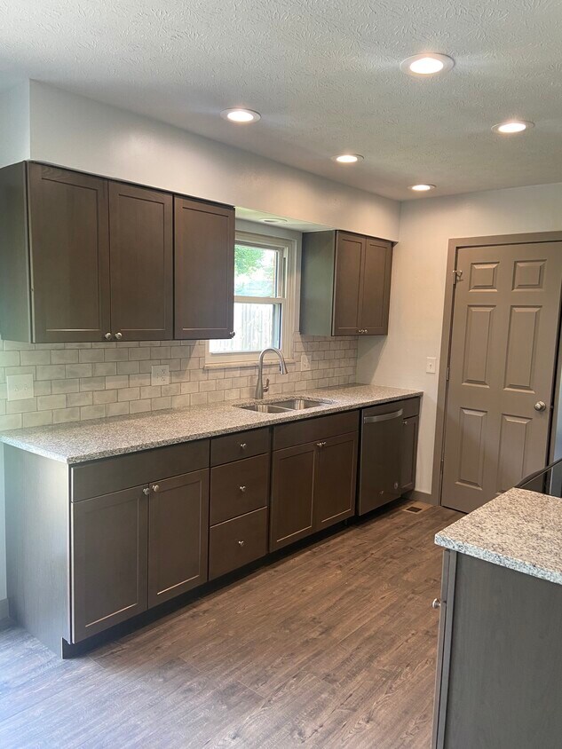 Remodeled Kitchen with granite counters, tile backsplash, and new appliances - 174 Brisbane Ave
