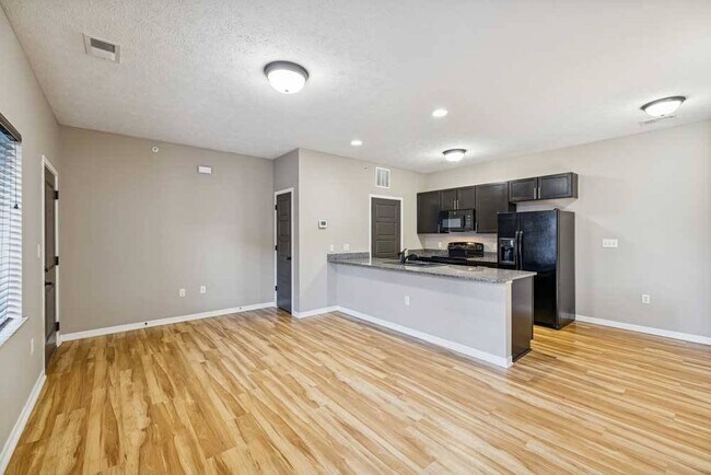 Modern finishes meet functional design in this open-concept kitchen and living space. - North Pointe Villas