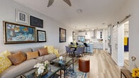 Located in Melbourne, FL, this well-appointed one-bedroom, one-bathroom residence offers a thoughtfully designed open-concept layout across a single floor. Light wood-look flooring flows throughout, unifying the living, dining, and kitchen areas into a cohesive, airy space. The living room features a ceiling fan, generous wall space for art display, and large windows that invite natural light. A central kitchen island with a stainless steel undermount sink and white quartz countertops anchors the chef-friendly kitchen, which is equipped with white shaker-style cabinetry, a stainless steel French door refrigerator, track lighting, and elegant pendant lights. The open dining area connects seamlessly to both the kitchen and living room, making the space ideal for entertaining. The bedroom is a comfortable retreat with ceiling fan, large windows with outdoor views, and ample natural light. The full bathroom features a glass-enclosed shower, a wide vanity with quartz countertops, open shelving for storage, and wood-look tile flooring. A dedicated laundry room includes white cabinetry, quartz countertops, and a utility sink. Two hallways provide efficient circulation throughout, complemented by a closet for additional storage.