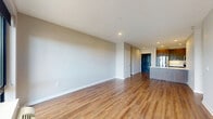 Located on E Pleasantview Ave in Hackensack, NJ, this well-designed single-floor residence offers three bedrooms, two bathrooms, and a dedicated closet. The open-concept living and kitchen area sets a welcoming tone, featuring warm hardwood flooring that extends throughout the unit. The kitchen is equipped with stainless steel appliances, including a French door refrigerator and dishwasher, complemented by rich dark wood cabinetry, white quartz countertops, a stainless steel sink, and recessed lighting overhead. The living area is bright and spacious, with neutral gray walls and clean lines that create a contemporary aesthetic. The generously sized primary bedroom offers ample space, while the additional bedrooms each feature hardwood floors, large windows with outdoor views, and individual climate control units. The two bathrooms are finished in a modern style — one features a wide vanity with dark wood cabinetry, a white quartz countertop, and marble-look tile flooring, while the other includes a tiled soaking tub and shower combination. Recessed lighting and neutral tones throughout lend a cohesive, move-in-ready feel to this thoughtfully laid-out Hackensack residence.
