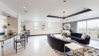 Located in Houston's prestigious Galleria corridor, this single-floor space offers a thoughtfully designed layout that blends contemporary elegance with functional living. Large-format light tile flooring flows throughout, creating a seamless and airy feel across the open-concept kitchen and living area.

The kitchen is a standout feature, showcasing textured white mosaic tile walls, dark granite countertops, a central island with bar seating, gold-accented pendant lighting, and stainless steel appliances. The adjacent living area is defined by a coffered ceiling with bold dark trim, recessed lighting, and a striking sputnik chandelier, lending the space a sophisticated, modern character. Sliding glass doors open directly onto a private balcony, offering panoramic views of the Houston skyline.

The dining room exudes refinement, centered around a white marble-top table beneath a sculptural ring chandelier. A dark navy sideboard with gold hardware anchors the room, complemented by bold abstract artwork and a richly patterned area rug.

An additional unclassified room provides flexible use, also featuring balcony access through sliding glass doors. Throughout, the interplay of charcoal gray accent walls, white surfaces, and gold finishes creates a cohesive, upscale aesthetic ideal for modern urban living.