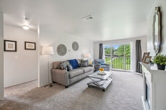 Elevated living room and private patio or balcony at Drawbridge Apartments in Harrison Township, MI. - Drawbridge Apartments East