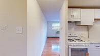 Located at 250 Beverly Blvd in Upper Darby, PA, this two-bedroom, one-bathroom residence is thoughtfully laid out across a single floor. The open-concept living and dining area is a standout feature, showcasing polished hardwood floors that reflect natural light streaming in through large windows. Baseboard heating and a wall-mounted AC unit ensure year-round comfort throughout the main living spaces.

The kitchen is efficiently designed with white cabinetry, a classic subway tile backsplash, a gas range, and a full-size refrigerator. Marble-look flooring in the kitchen adds a clean, contemporary touch that transitions seamlessly into the living area.

Both bedrooms are carpeted for warmth and comfort. Each room features neutral walls, ample natural light from windows with outdoor views, and closet space — with built-in closets providing convenient storage. The primary bedroom is a comfortable size, well-suited for a full bedroom suite.

The bathroom is clean and modern, featuring a tub/shower combination with large-format marble-style wall tiles that lend an elegant finish. A hallway connects the living spaces to the bedrooms and bathroom, with four closets distributed throughout the unit offering generous storage. The overall ambiance is bright, clean, and move-in ready.