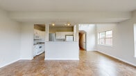 Located at 23 Delano Dr in Chambersburg, PA, this two-story, five-bedroom, three-bathroom home offers a thoughtfully designed layout spread across two floors. The main level welcomes you with a bright, open-concept kitchen and living area finished with large tile flooring. The kitchen features white cabinetry, granite countertops, a peninsula island, and track lighting, with soaring ceilings that draw in abundant natural light from high windows. French doors in the living area open to the outdoors, further enhancing the airy feel. A dedicated laundry room with cabinetry and counter space adds everyday convenience on this level. A carpeted staircase with a white handrail leads to the upper floor, where the five bedrooms are located. The generously sized primary bedroom boasts vaulted ceilings, a large arched window with outdoor views, and plush carpeting. A walk-in closet with wire shelving provides ample storage. Additional bedrooms offer carpet flooring and built-in closets. The bathrooms are finished with tile flooring and include tub-shower combinations. A hallway with arched doorways and tile flooring connects the main living spaces, contributing to the home's clean, cohesive aesthetic throughout.