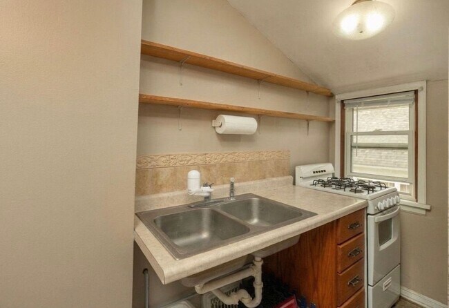 Kitchenette coupled with double sink, stove/oven and refrigerator - 1126 7th Ave SE