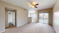 Located at 3333 Turtle Creek Dr in Port Arthur, TX, this single-floor, 2-bedroom, 1-bathroom residence offers a functional and comfortable layout with a neutral, warm color palette throughout. The living area is carpeted and generously sized, featuring a ceiling fan and access to a private balcony through a sliding glass door, bringing in natural light and outdoor views. The front entry opens into this welcoming space, with a separate doorway leading further into the home.

The spacious primary bedroom is one of the standout features of this residence, offering expansive carpet flooring, a ceiling fan, large windows that invite abundant natural light and exterior views, and direct access to an additional room. The second bedroom is equally well-appointed with carpet flooring, a ceiling fan, and a large window overlooking the surrounding community.

A dedicated walk-in closet features built-in wire shelving on multiple walls, providing ample storage. The bathroom includes a full tub-and-shower combination with tiled surround, overhead cabinetry, and wood-look flooring. The in-unit laundry area is conveniently tucked away with wood-look flooring and built-in shelving. The kitchen completes this well-rounded layout, making this a practical and inviting home.