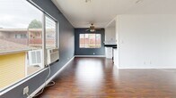 Located in the heart of West Hollywood, this 2-bedroom, 2-bathroom residence offers a well-designed single-level layout that makes efficient use of its space. Rich, dark wood-look flooring runs throughout, providing a warm and cohesive foundation across all living areas.

The open living room features bold slate-blue accent walls, a ceiling fan, and large windows that invite natural light and outdoor views. It connects seamlessly to the galley-style kitchen, which is outfitted with white shaker cabinetry, dark countertops, and a full suite of stainless steel appliances including a gas range, built-in microwave, dishwasher, and refrigerator.

Both bedrooms continue the consistent flooring and clean white walls, with the primary bedroom featuring its own ceiling fan, a large window with a curtain rod, and a slate accent wall. The second bedroom is bright and cleanly finished, offering a quiet and functional space.

The two bathrooms are finished with light tile flooring and crisp white walls. One bathroom includes a full soaking tub and shower combination with a window for ventilation, paired with a dark-finished vanity and white countertop. The layout is completed by a connecting hallway that ties all rooms together efficiently.
