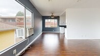 Located in the heart of West Hollywood, this 2-bedroom, 2-bathroom residence offers a well-designed single-level layout that makes efficient use of its space. Rich, dark wood-look flooring runs throughout, providing a warm and cohesive foundation across all living areas.

The open living room features bold slate-blue accent walls, a ceiling fan, and large windows that invite natural light and outdoor views. It connects seamlessly to the galley-style kitchen, which is outfitted with white shaker cabinetry, dark countertops, and a full suite of stainless steel appliances including a gas range, built-in microwave, dishwasher, and refrigerator.

Both bedrooms continue the consistent flooring and clean white walls, with the primary bedroom featuring its own ceiling fan, a large window with a curtain rod, and a slate accent wall. The second bedroom is bright and cleanly finished, offering a quiet and functional space.

The two bathrooms are finished with light tile flooring and crisp white walls. One bathroom includes a full soaking tub and shower combination with a window for ventilation, paired with a dark-finished vanity and white countertop. The layout is completed by a connecting hallway that ties all rooms together efficiently.