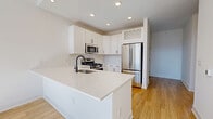 This contemporary apartment in Merrillville, IN, offers 1120 square feet of thoughtfully designed living space. The open-concept layout seamlessly integrates the kitchen, living, and dining areas, creating a spacious feel. The kitchen is a highlight, featuring sleek white cabinetry, stainless steel appliances, and a large island with a modern sink and faucet.

Both bedrooms are generously sized, with the primary bedroom measuring 170 square feet. Large windows in the bedrooms provide abundant natural light and scenic views. The two bathrooms are elegantly appointed, featuring modern fixtures, tiled showers, and ample storage.

Throughout the apartment, beautiful hardwood floors add warmth and character. The laundry room and two closets offer practical storage solutions. Recessed lighting and ceiling fans contribute to the overall modern aesthetic.

The apartment's neutral color palette and clean lines create a blank canvas for personal style. High ceilings and strategically placed windows maximize natural light, creating a bright and airy atmosphere. This well-designed space combines functionality with contemporary flair, perfect for modern living in Merrillville.