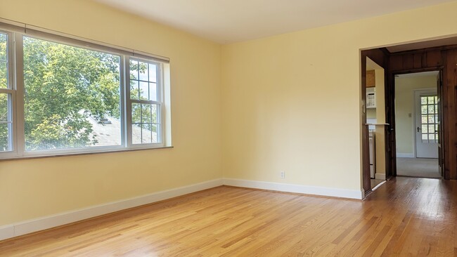 Hardwood floors in living room and dining area. - 2810 Victoria Ave