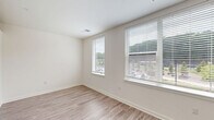 This 470 square foot apartment in Fort Washington, PA, showcases a thoughtful design that maximizes space and functionality. The single-floor layout comprises one bedroom, one bathroom, a kitchen, and a hallway, creating an efficient living space.

The bathroom boasts a clean, modern aesthetic with marble-look tile in the shower area, a white vanity with ample storage, and a standard toilet. The wood-look flooring adds warmth to the sleek design.

The kitchen is a highlight, featuring crisp white cabinetry that extends to the ceiling, maximizing storage. Stainless steel appliances, including a refrigerator, oven, and dishwasher, complement the contemporary design. A subway tile backsplash and light-colored countertops enhance the bright, airy feel. Large windows allow natural light to flood the space, while also offering views of the surrounding area.

The bedroom, measuring 130 square feet, is carpeted for comfort and includes a built-in shelf, perfect for storage or display. Recessed lighting throughout the apartment provides even illumination and contributes to the modern ambiance.

The open concept design creates a sense of spaciousness, with the kitchen flowing seamlessly into the living area. The consistent use of light colors and materials throughout enhances the perception of space in this compact yet well-appointed apartment.