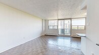 Located at 1360 Danforth Rd in Toronto's Scarborough community, this well-appointed 2-bedroom, 1-bathroom unit offers a comfortable and functional layout across a single floor. Parquet hardwood flooring flows throughout the living spaces, adding warmth and character to the interior.

The open-concept living room is generously sized, bathed in natural light through large floor-to-ceiling sliding glass doors that lead to a balcony with scenic views of the surrounding greenery and cityscape. The renovated kitchen is a standout feature, boasting crisp white shaker cabinetry, a classic subway tile backsplash, dark countertops, and a full suite of stainless steel appliances, including a refrigerator, stove, microwave, and dishwasher. Light tile flooring completes the clean, modern aesthetic.

The spacious primary bedroom offers ample natural light from a wide window and features two mirrored sliding closets, providing generous storage. The second bedroom is bright and versatile, with its own window framing neighbourhood views. The bathroom is finished with white subway tile surrounding a full soaking tub and shower, complemented by stone-look floor tiles for a clean, timeless look.