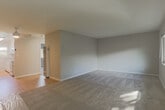 Located at 658 Sierra Vista Ave in Mountain View, CA, this single-story 1-bedroom, 1-bathroom home offers a practical and well-organized layout. The combined kitchen and living area forms the heart of the home, with the kitchen featuring white cabinetry, granite-style countertops, a full suite of white appliances including an electric range and refrigerator, and hardwood flooring. A window above the sink allows natural light to brighten the space. The living room transitions seamlessly from the kitchen, with neutral carpet, soft gray walls, and a front entry door that brings in additional light. The bedroom is a comfortable, well-proportioned room with plush carpet, large windows overlooking greenery, and ample wall space. A dedicated closet with a paneled door adds practical storage. The bathroom is finished with white tile and features a tub-shower combination enclosed by a glass sliding door, complemented by a frosted window that provides both light and privacy. Throughout the home, a consistent neutral color palette and clean finishes create a calm, cohesive ambiance. Situated in the heart of Silicon Valley, this Mountain View residence offers convenient access to local amenities, parks, and major tech campuses.