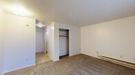 Located at 1901 Union St in Lafayette, Indiana, this one-bedroom, one-bathroom unit offers an efficient and functional single-floor layout. The bedroom is the largest room in the unit, featuring wall-to-wall carpeting, a sliding-door closet with a hanging rod and shelf, a baseboard heater, and a large window dressed with vertical blinds that allow for generous natural light. The compact kitchen is thoughtfully equipped with white cabinetry above and below the counter, a white electric range, a double-basin sink, and a black refrigerator. Patterned vinyl flooring adds a distinct character to the kitchen area. The bathroom includes a vanity with under-sink storage, a toilet, and a tub/shower combination enclosed by a curtain, with matching patterned vinyl flooring tying the space together. Throughout the unit, textured ceilings and neutral white walls provide a clean, understated backdrop. The single-floor layout keeps the space easy to navigate, making it a straightforward and practical living option in the Lafayette area.