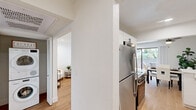 Located at 444 Saratoga Ave in Santa Clara, CA, this thoughtfully designed single-floor home offers three bedrooms and three full bathrooms within a well-organized layout. The living room is bright and inviting, featuring light hardwood flooring, recessed lighting, and a sliding glass door that opens to the outdoors, creating a seamless indoor-outdoor flow. The galley-style kitchen is a standout feature, showcasing white shaker cabinetry with matte black hardware, quartz countertops, a subway tile backsplash, a matte black sink fixture, and stainless steel appliances. The bedrooms are carpeted for comfort, including a spacious primary bedroom with recessed lighting and natural light from window blinds. The additional bedrooms offer equally clean, neutral finishes. The three bathrooms are well-appointed: one features a walk-in glass-door shower with white tile surround and hardwood-style flooring, another includes a full soaking tub with curtain enclosure, and the primary bath offers a wide quartz vanity with white cabinetry and ample storage. Hallways connect the rooms efficiently, and the consistent use of white walls and warm flooring throughout gives the home a cohesive, modern aesthetic.