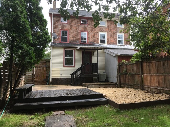 Cozy private patio and deck with large fenced in yard. - 817 W Bridge St