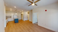 This single-story residence in Slidell, Louisiana offers a comfortable and modern living experience with two bedrooms and two full bathrooms. The open-concept main living area seamlessly connects the kitchen, dining, and living spaces, all finished with warm wood-look luxury vinyl plank flooring. The kitchen is a standout feature, boasting crisp white shaker cabinetry, granite countertops, a central island with pendant lighting overhead, and white appliances including a refrigerator, range, and built-in microwave. Natural light fills the living area through a large window, complemented by a ceiling fan that enhances airflow and comfort. The bedrooms are carpeted for warmth and comfort, each with a ceiling fan and window offering outdoor views. The primary bathroom features a dual-sink vanity with granite countertops, white cabinetry, and direct access to a spacious walk-in closet with wire shelving. The second bathroom is equally well-finished. Throughout the unit, neutral tones and clean lines create a bright, cohesive ambiance. Multiple closets and storage spaces add practical functionality to this thoughtfully designed residence.