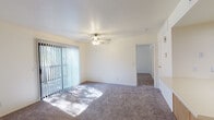 Located at 8851 N Oracle Rd in Oro Valley, Arizona, this single-floor unit offers a well-organized layout designed for comfortable everyday living. The living area is generously sized, featuring plush carpeting, a ceiling fan with light fixture, and a sliding glass door dressed with vertical blinds that allows abundant natural light to pour in while providing access to the outdoors.

The kitchen is practical and efficiently laid out, offering warm honey-toned wood cabinetry, light countertops, a built-in electric range, a full-size refrigerator, a dishwasher, and a sink. A pass-through counter connects the kitchen to the adjacent dining and entry area, which features easy-care hard-surface flooring. A private entry door leads directly into this space, adding convenience.

The bedrooms are carpeted and bathed in natural light through large windows with vertical blinds, creating a calm and restful atmosphere. Each room provides a clean, neutral palette ready for personalization.

The bathroom is equipped with a tub-shower combination, a wood-cabinet vanity with light countertop, and hard-surface flooring that complements the rest of the unit. Throughout the space, the neutral tones, consistent finishes, and abundance of natural light contribute to a clean, functional, and inviting environment.