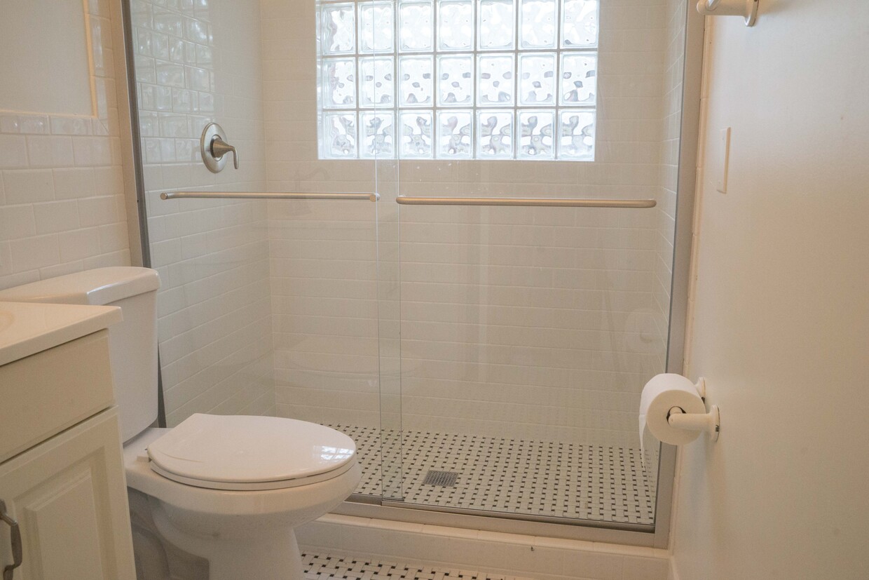 Bathroom with large shower and white subway tile. - 2040 Arlington Ave NE