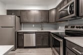 Located at 1810 Kuser Road in Trenton, NJ, this single-floor unit offers a well-organized layout that balances functional living and dining spaces with comfortable private areas. The open living and dining zone is finished with plush wall-to-wall carpeting and neutral-toned walls, creating a clean, versatile backdrop. A chandelier anchors the dining area, adding a subtle decorative touch, while baseboard heating runs along the perimeter, ensuring consistent warmth throughout. The living area benefits from natural light through a broad multi-pane window that frames views of the surrounding greenery, complemented by a wall-mounted AC unit for climate control.

The kitchen stands out as a well-appointed space, featuring dark-toned cabinetry with brushed nickel hardware, light quartz countertops, and a subway tile backsplash. Stainless steel appliances—including a refrigerator, electric range, and over-the-range microwave—are paired with light wood-look flooring and skylight-style ceiling panels that brighten the space. A peninsula counter connects the kitchen to the living area, enhancing flow.

The bedrooms are carpeted and neutrally finished, each offering access to a dedicated walk-in closet, providing ample storage. The overall ambiance is clean, bright, and move-in ready.