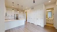 Located in Houston's sought-after 77008 zip code, this thoughtfully designed one-bedroom, one-bathroom residence offers a clean, modern aesthetic with high-quality finishes throughout. The open-concept layout seamlessly connects the kitchen, dining, and living areas, creating a bright and airy atmosphere enhanced by recessed lighting and a ceiling fan. The kitchen is a standout feature, boasting white shaker cabinetry with matte black hardware, a large waterfall-edge island with an undermount sink, stainless steel appliances including a French door refrigerator and range, a built-in microwave, and a wine rack — all illuminated by a trio of elegant glass pendant lights. Light wood-look flooring flows consistently throughout the main living spaces, adding warmth to the crisp white palette. The bedroom is generously sized, filled with natural light from two large windows with blinds. A dedicated office provides flexible space for remote work or study. The bathroom impresses with marble-style tiled shower walls, a soaking tub, white dual-sink vanity with matte black fixtures, open built-in shelving, and elegant tile flooring. Additional highlights include three closets, a laundry area, and a welcoming entrance — delivering exceptional functionality.
