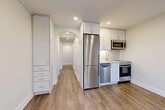 Located at 627 Eglinton Ave W in Toronto's vibrant Midtown neighbourhood, this well-appointed 2-bedroom, 1-bathroom unit blends classic architectural charm with modern updates. Warm hardwood-style flooring flows throughout, complemented by crisp white walls and clean baseboards that create a bright, cohesive feel.

The kitchen is efficiently designed with white cabinetry reaching to the ceiling, stainless steel appliances including a full-size refrigerator, dishwasher, microwave, and gas range, plus a subway tile backsplash. A graceful arched passageway connects the kitchen to the hallway, adding a distinctive architectural touch. The combined dining and living area offers a functional open layout, while the hallway provides access to four closets, maximizing storage throughout.

Both bedrooms are bright and tranquil, featuring large multi-pane windows that bring in natural light and views of the surrounding neighbourhood. Classic cast-iron radiators in each bedroom nod to the building's heritage character. The bathroom is finished in white tile with a soaking tub and a frosted window for privacy.

A private balcony with glass railings offers open views of Eglinton Avenue and the surrounding streetscape. This unit offers an ideal combination of character details and contemporary convenience in a prime Toronto location.