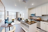 Located at 501 North Christopher Columbus Boulevard in Philadelphia, PA, this 2-bedroom, 2-bathroom residence offers a thoughtfully designed single-floor layout. The open-concept living and dining area is bright and welcoming, featuring wood-style plank flooring, recessed lighting, and large windows that flood the space with natural light. The contemporary kitchen is equipped with stainless steel appliances, white flat-front cabinetry extending to the ceiling, a subway tile backsplash, dark countertops, and a movable island with additional storage. The living area flows seamlessly from the kitchen, creating an ideal space for entertaining. The primary bedroom features plush carpeting, large windows, and a generous closet with built-in shelving systems. The second bedroom is equally well-appointed with ample natural light and closet space. Both bathrooms are finished with clean, modern fixtures, wood-style flooring, and sleek vanities. Additional conveniences include two closets and in-unit laundry. The overall aesthetic is clean and contemporary, with a neutral palette complemented by modern finishes throughout, offering a comfortable and functional living environment in Philadelphia's vibrant waterfront corridor.