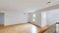 Located at 909 Westridge Gardens Way in Phoenixville, PA, this well-appointed 2-bedroom, 3-bathroom home offers a clean, modern aesthetic with thoughtful finishes throughout. The open living area is a standout, featuring warm hardwood flooring, crisp white walls, and a sleek black fireplace that serves as a striking focal point. A pendant light fixture and open staircase with a wood-and-metal railing add architectural character to the space. Large sliding glass doors and multiple windows flood the living area with natural light and provide views of the surrounding greenery.

The galley-style kitchen is efficiently designed with gray shaker cabinets, dark granite countertops, stainless steel appliances including a refrigerator and over-the-range microwave, and hardwood flooring that ties seamlessly into the main living space.

Both bedrooms are carpeted and well-lit by natural light from framed windows, each offering closet storage. The primary bedroom is generously sized. The three bathrooms are finished in a clean, contemporary style with gray cabinetry, white countertops, and light tile flooring. A dedicated laundry room houses a full-size washer and dryer. This home combines functional design with comfortable living in a desirable Phoenixville location.
