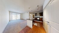 Located at 3310 S Kenton St in Denver, CO, this one-bedroom, one-bathroom residence offers a thoughtfully designed single-floor layout that maximizes comfort and functionality. The open-concept living and kitchen area serves as the heart of the home, where rich hardwood flooring transitions seamlessly into plush carpeting in the living space. A large window floods the living area with natural light and provides a view of the outdoor balcony area.

The kitchen is a standout feature, showcasing dark espresso cabinetry, sleek granite countertops, and a full suite of stainless steel appliances including a refrigerator and microwave. A peninsula with an integrated sink and additional granite counter space offers both a prep area and a casual seating option. Stylish pendant lighting and track lighting illuminate the space with a modern touch.

The bedroom is a comfortably sized, carpeted retreat featuring a ceiling fan, a natural-light-welcoming window, and a dedicated closet. The full bathroom continues the cohesive design with dark wood cabinetry, a granite vanity countertop, a tub-shower combination, and tile flooring. A hallway connects the rooms, adding to the efficient and well-organized flow of this Denver residence.