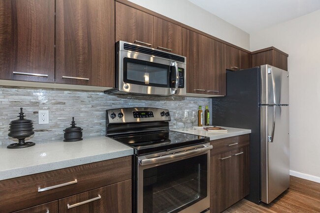 Kitchen with stainless steel appliances - The Canyons at Linda Vista Trail