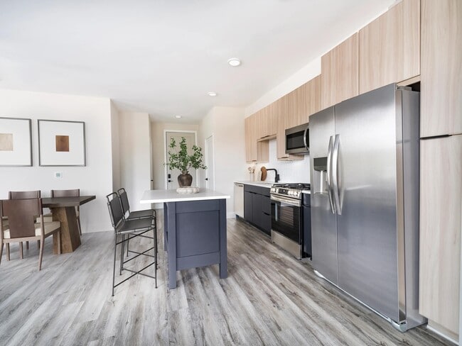 Sleek kitchens at Modera Westside Trail feature a spacious island and multiple contemporary finish options, creating a refined space for everyday living. - Modera Westside Trail Apartments