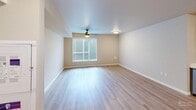 Located at 15247 Tukwila International Blvd in SeaTac, WA, this efficiently designed studio offers a thoughtfully organized single-floor layout. Light-toned luxury vinyl plank flooring runs throughout, lending a clean and cohesive look to the entire space.

The open-plan living, dining, and kitchen area serves as the heart of the unit. The living area features a ceiling fan, a flush-mount light fixture, and a window that invites natural light into the room. The kitchen is equipped with stainless steel appliances — including a refrigerator, electric range, built-in microwave, and dishwasher — complemented by light wood cabinetry, white quartz-style countertops, a double-basin sink, and directional track lighting overhead.

The bathroom is finished with warm wood-toned cabinetry, a white countertop vanity with a single sink, a large mirror, and wood-look vinyl flooring that mirrors the rest of the unit. The space is clean and functional in its design.

A dedicated laundry area houses a stacked Whirlpool washer and dryer unit, adding everyday convenience. An additional room with a window and flush-mount ceiling light provides flexible space suitable for use as a bedroom or additional living area. A closet completes the layout, providing essential storage. The overall ambiance is modern, bright, and move-in ready.