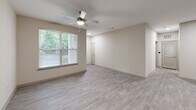 Located at 7121 Finn Hall Ave in Charlotte, NC, this single-story, one-bedroom, one-bathroom home offers a well-designed layout making efficient use of its space. Light-toned, wood-look flooring flows consistently throughout, creating a cohesive and clean aesthetic across every room.

The combined kitchen and living area serves as the heart of the home. The kitchen is outfitted with gray shaker-style cabinetry, granite countertops, a white subway tile backsplash, and a full suite of stainless steel appliances including a refrigerator, electric range, microwave, and dishwasher. Recessed lighting adds a polished finish to this functional space.

The living room benefits from large windows fitted with blinds, inviting natural light and views of surrounding greenery. A ceiling fan overhead provides year-round comfort. The bedroom is generously proportioned, featuring its own ceiling fan, a sizable window with natural views, a closet, and direct access to the hallway.

The bathroom is thoughtfully laid out, offering a granite-topped vanity with white cabinetry, ample storage, and wood-look flooring that mirrors the rest of the home. A hallway connects the living areas seamlessly, and an attached private garage with a concrete floor provides dedicated parking and additional storage capacity.