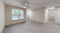 Located at 7121 Finn Hall Ave in Charlotte, NC, this single-story, one-bedroom, one-bathroom home offers a well-designed layout making efficient use of its space. Light-toned, wood-look flooring flows consistently throughout, creating a cohesive and clean aesthetic across every room.

The combined kitchen and living area serves as the heart of the home. The kitchen is outfitted with gray shaker-style cabinetry, granite countertops, a white subway tile backsplash, and a full suite of stainless steel appliances including a refrigerator, electric range, microwave, and dishwasher. Recessed lighting adds a polished finish to this functional space.

The living room benefits from large windows fitted with blinds, inviting natural light and views of surrounding greenery. A ceiling fan overhead provides year-round comfort. The bedroom is generously proportioned, featuring its own ceiling fan, a sizable window with natural views, a closet, and direct access to the hallway.

The bathroom is thoughtfully laid out, offering a granite-topped vanity with white cabinetry, ample storage, and wood-look flooring that mirrors the rest of the home. A hallway connects the living areas seamlessly, and an attached private garage with a concrete floor provides dedicated parking and additional storage capacity.