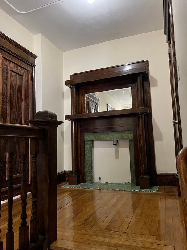 Stairs to second floor front hallway and front door - 32 W Alvord St